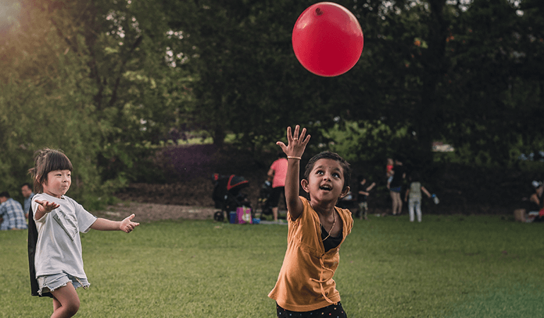Kids playing with a balloon outside